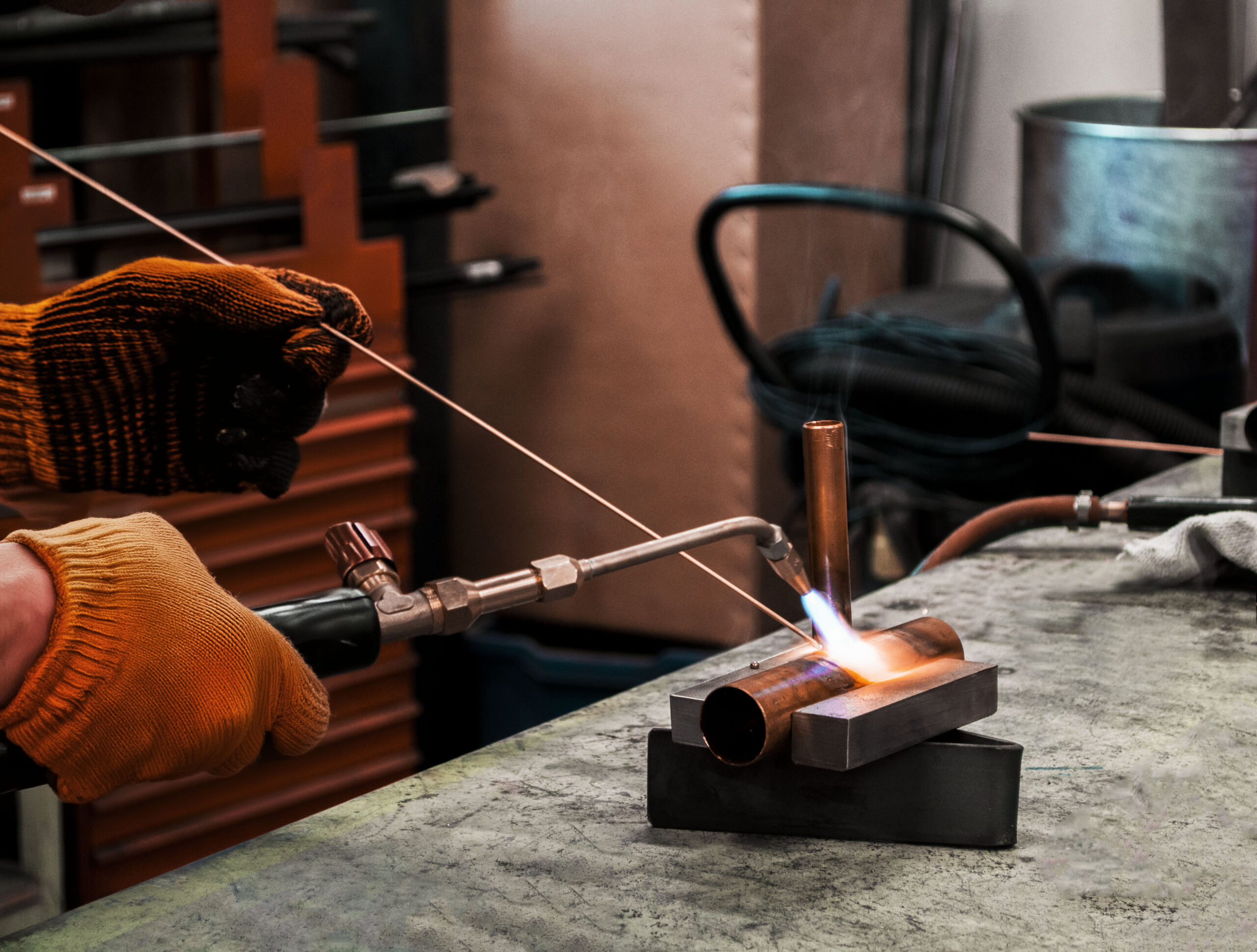 Soudage de deux morceaux de tuyau en métal avec un chalumeau