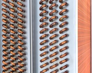 stock-photo-close-shot-of-copper-plain-tubes-of-a-condenser-coil-2398091081