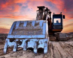 stock-photo-excavator-on-groundwork-on-dramatic-twilight-excavator-on-sunset-background-open-pit-mining-2492320917