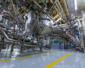 stock-photo-stainless-vertical-steel-tanks-and-pipes-with-pressure-meter-in-equipment-tank-chemical-cellar-at-2482590717